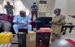 photo of Senator James Manager kneeling before his benefactor, James Ibori