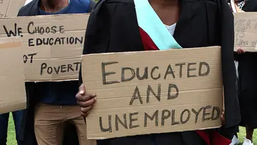 unemployed young nigerians carrying placard during a protest